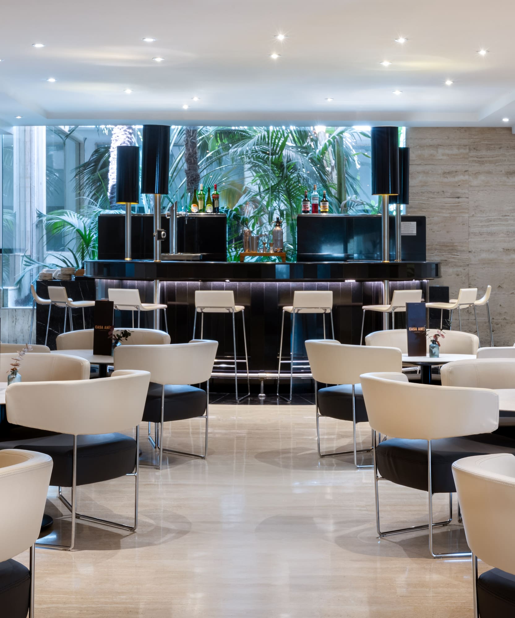 a room with white tables and chairs