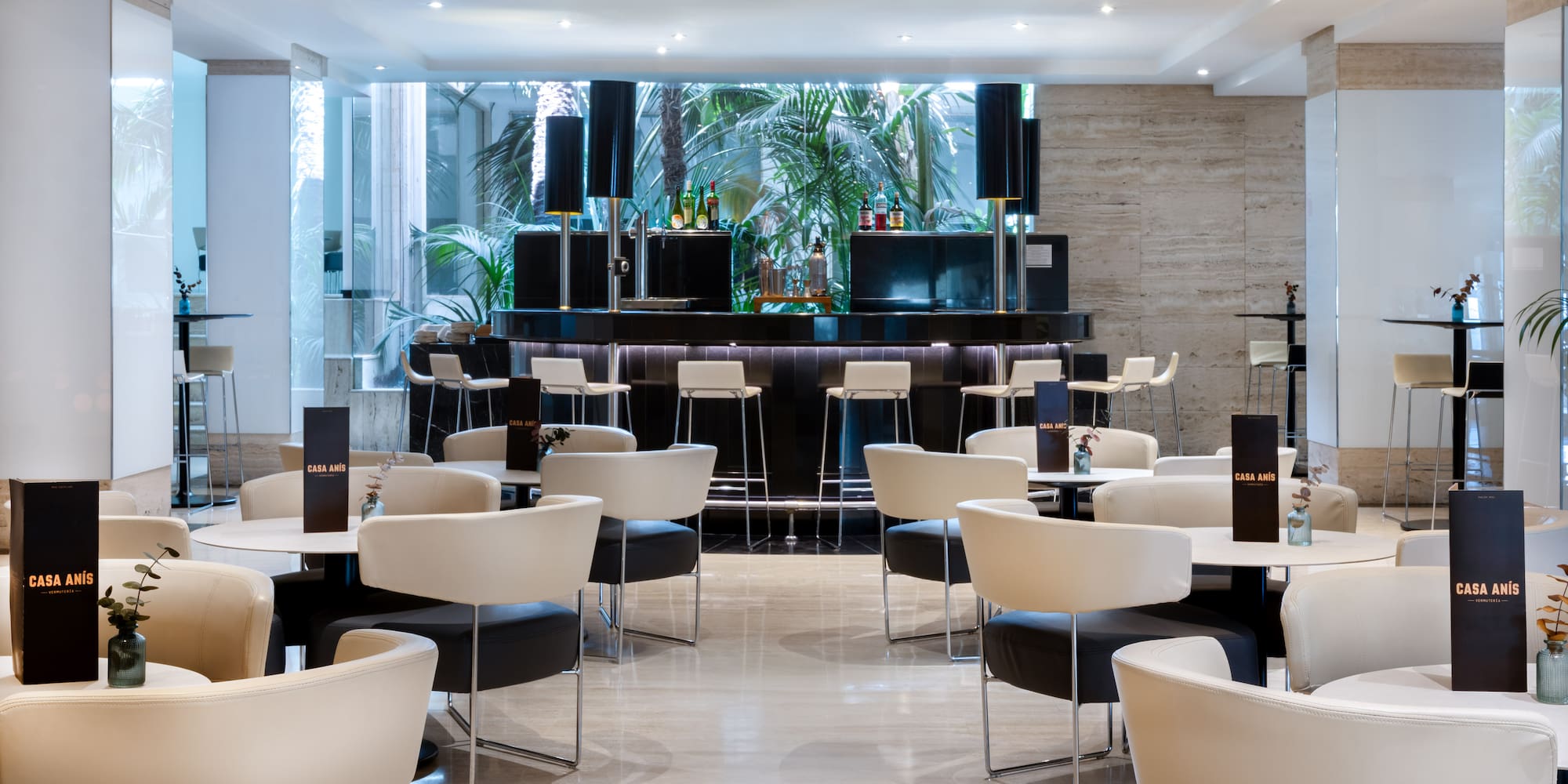 a room with white tables and chairs