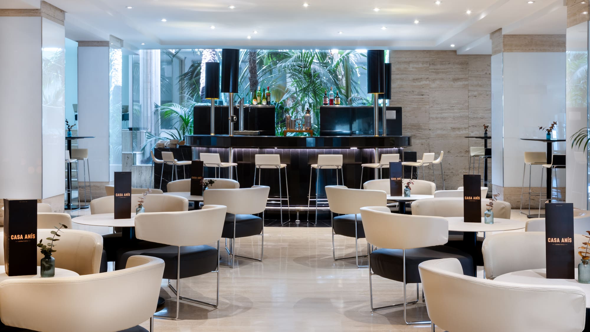 a room with white tables and chairs