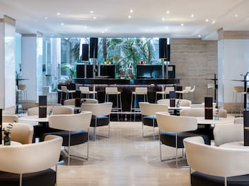 a room with white tables and chairs