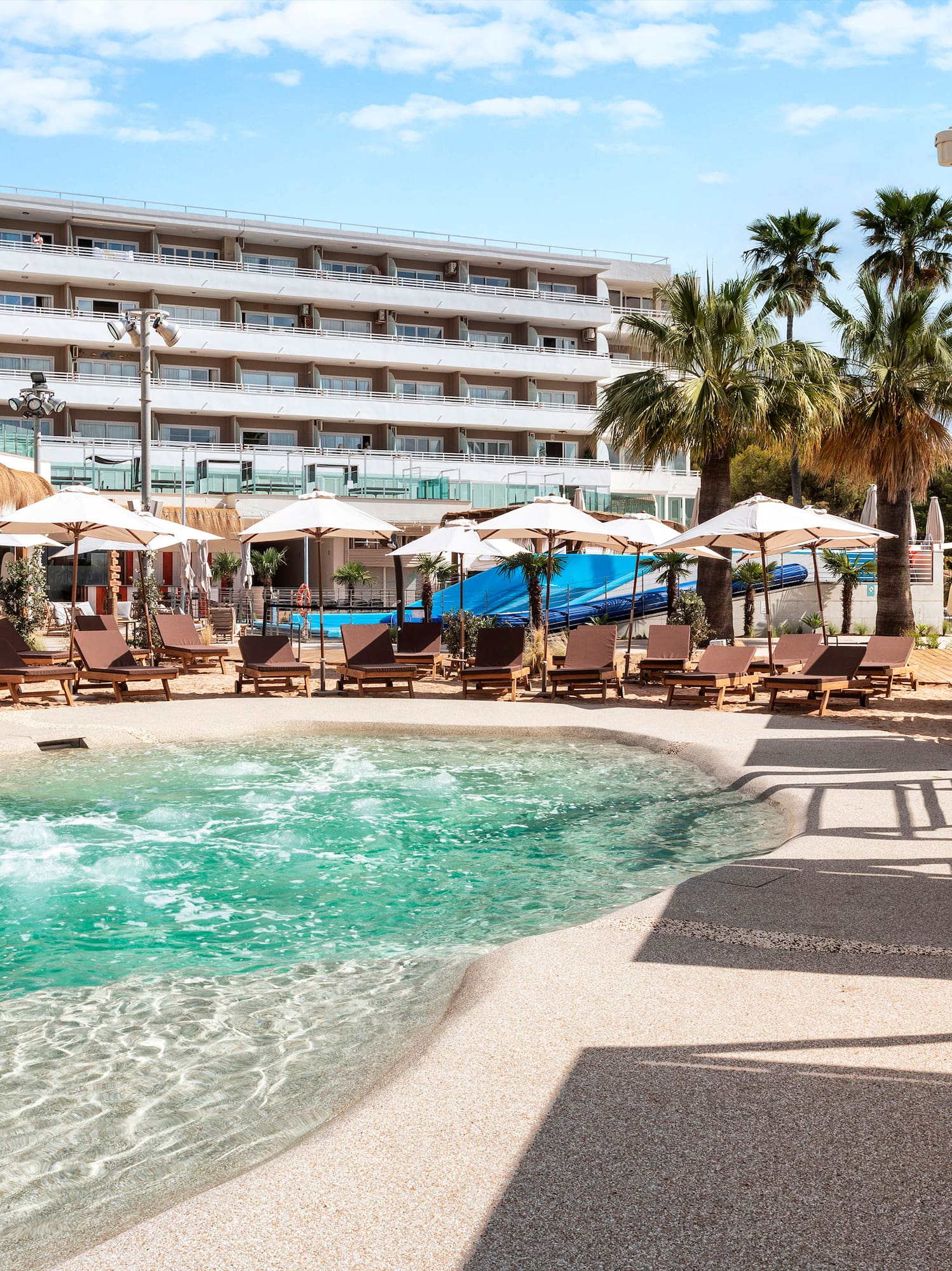 a pool with umbrellas and chairs