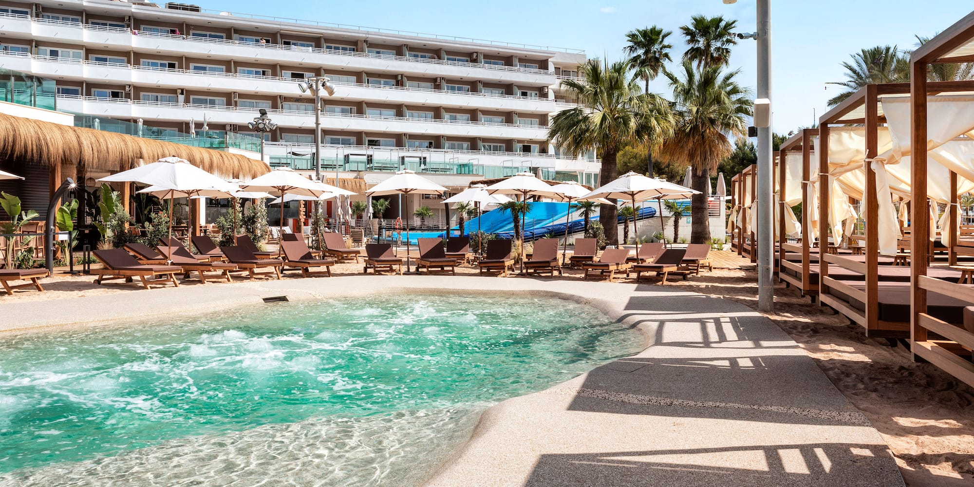 a pool with umbrellas and chairs