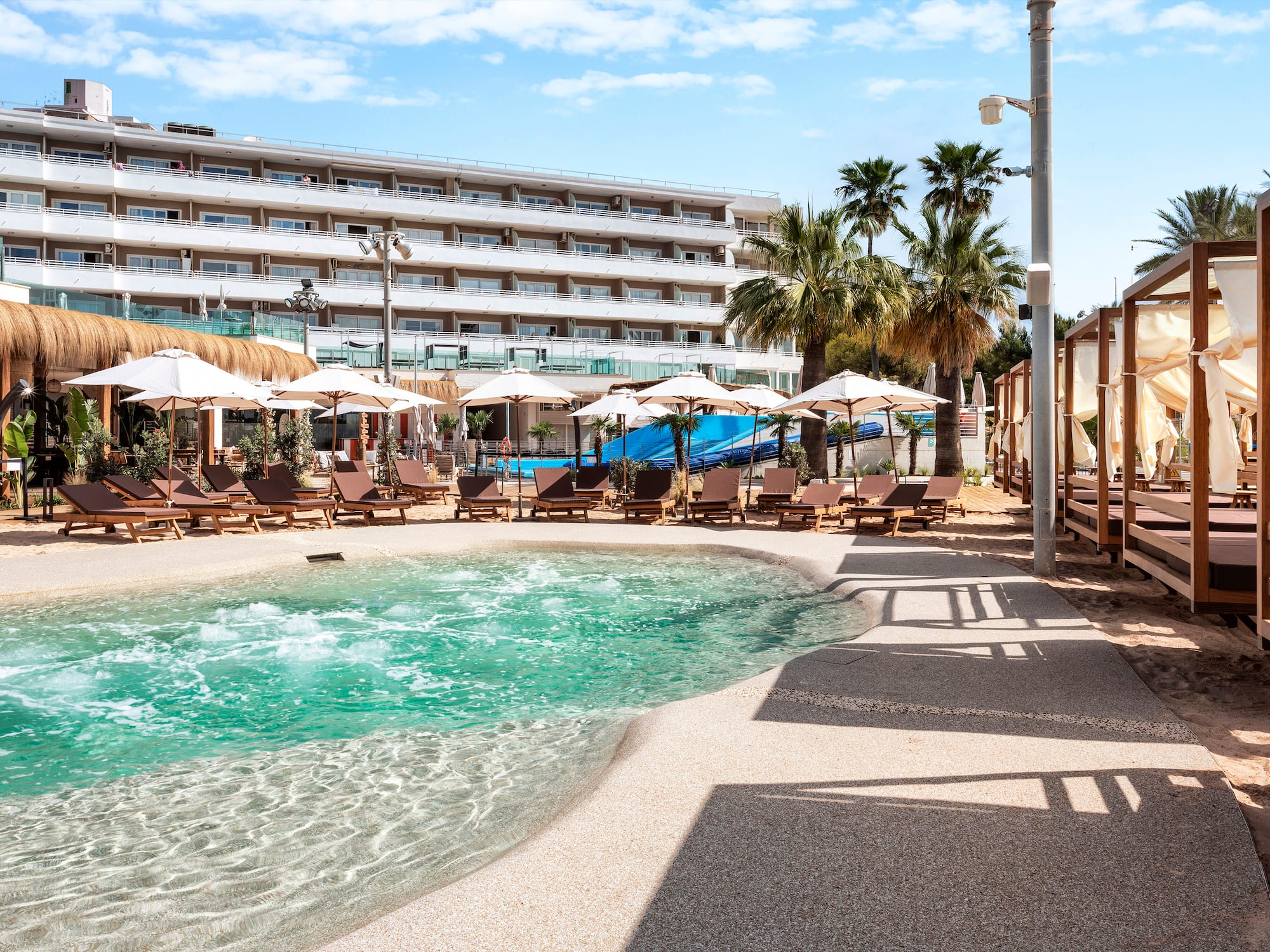 a pool with umbrellas and chairs