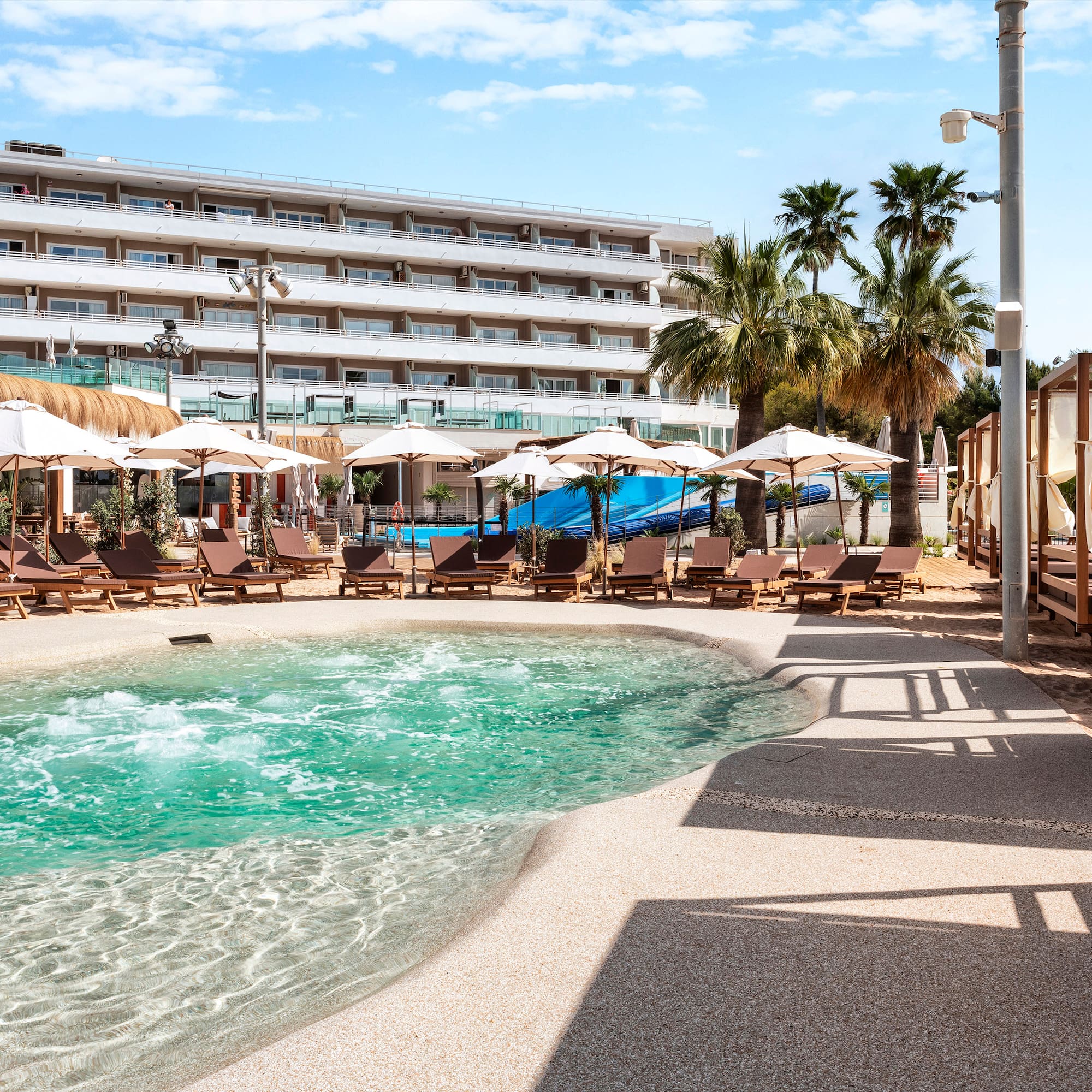 a pool with umbrellas and chairs