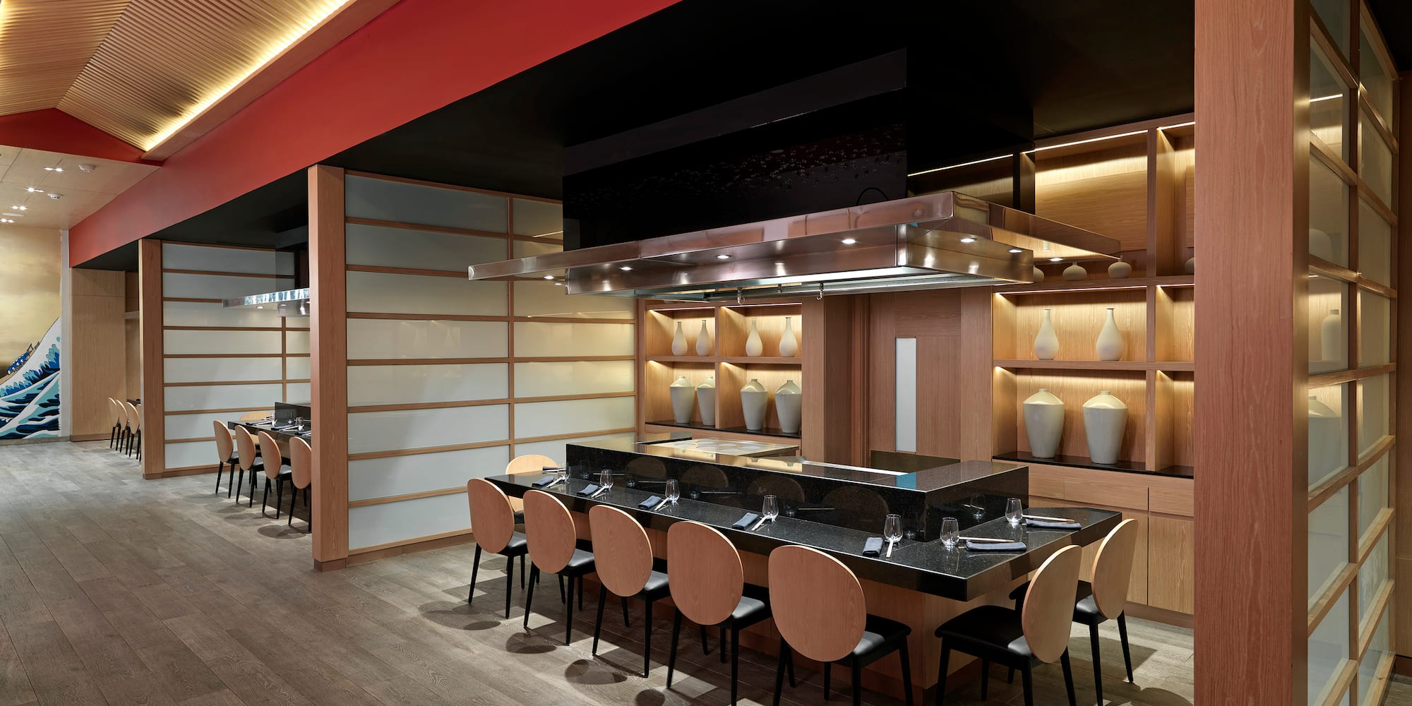 a restaurant with a long table and chairs