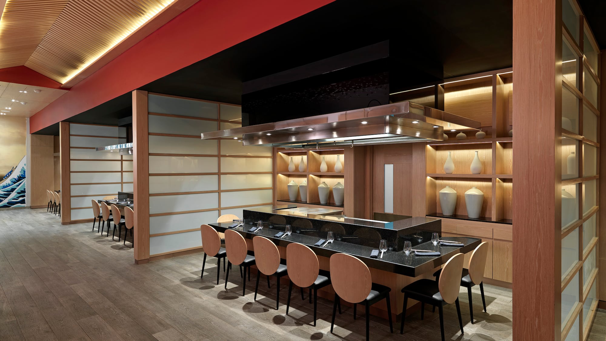 a restaurant with a long table and chairs