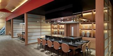 a restaurant with a long table and chairs