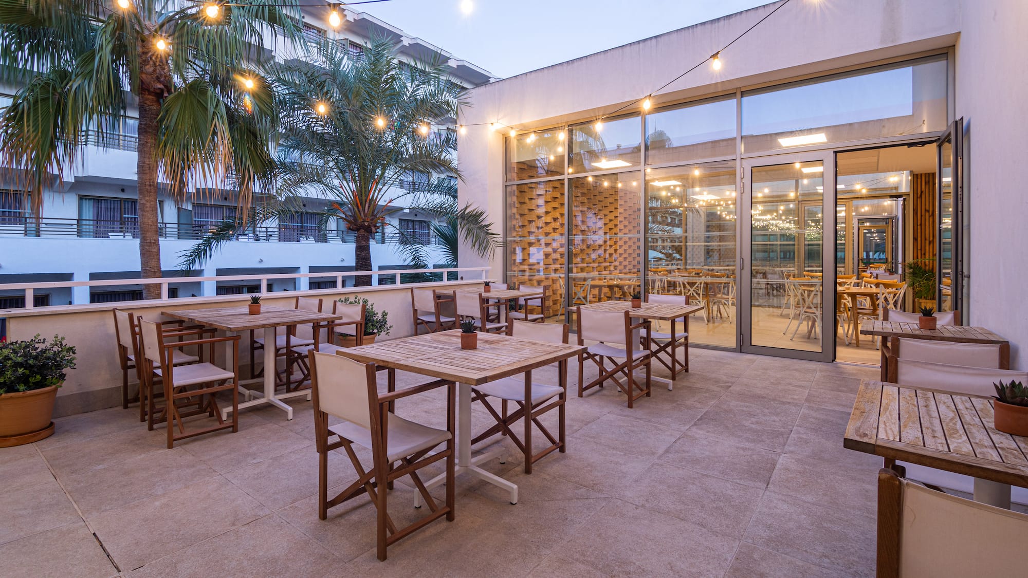 a patio with tables and chairs
