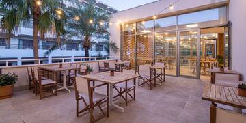 a patio with tables and chairs