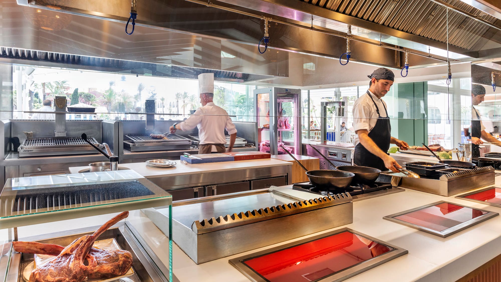 a group of chefs cooking in a kitchen