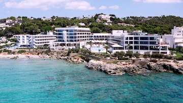 a group of white buildings next to a body of water