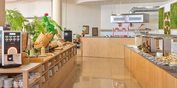 a kitchen with a buffet and a plant