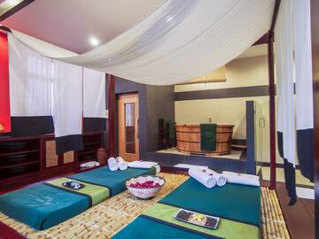 a room with a large bed and towels