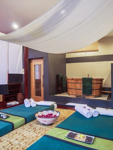 a room with a large bed and towels