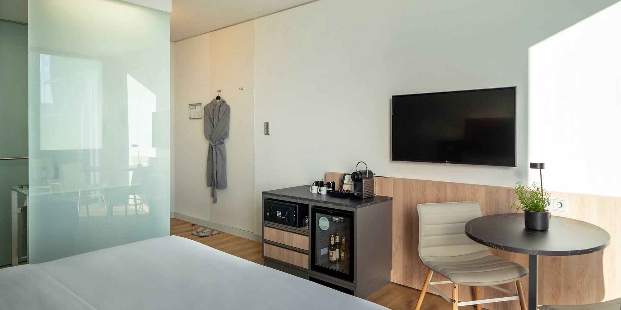 a room with a bed and a table and chair