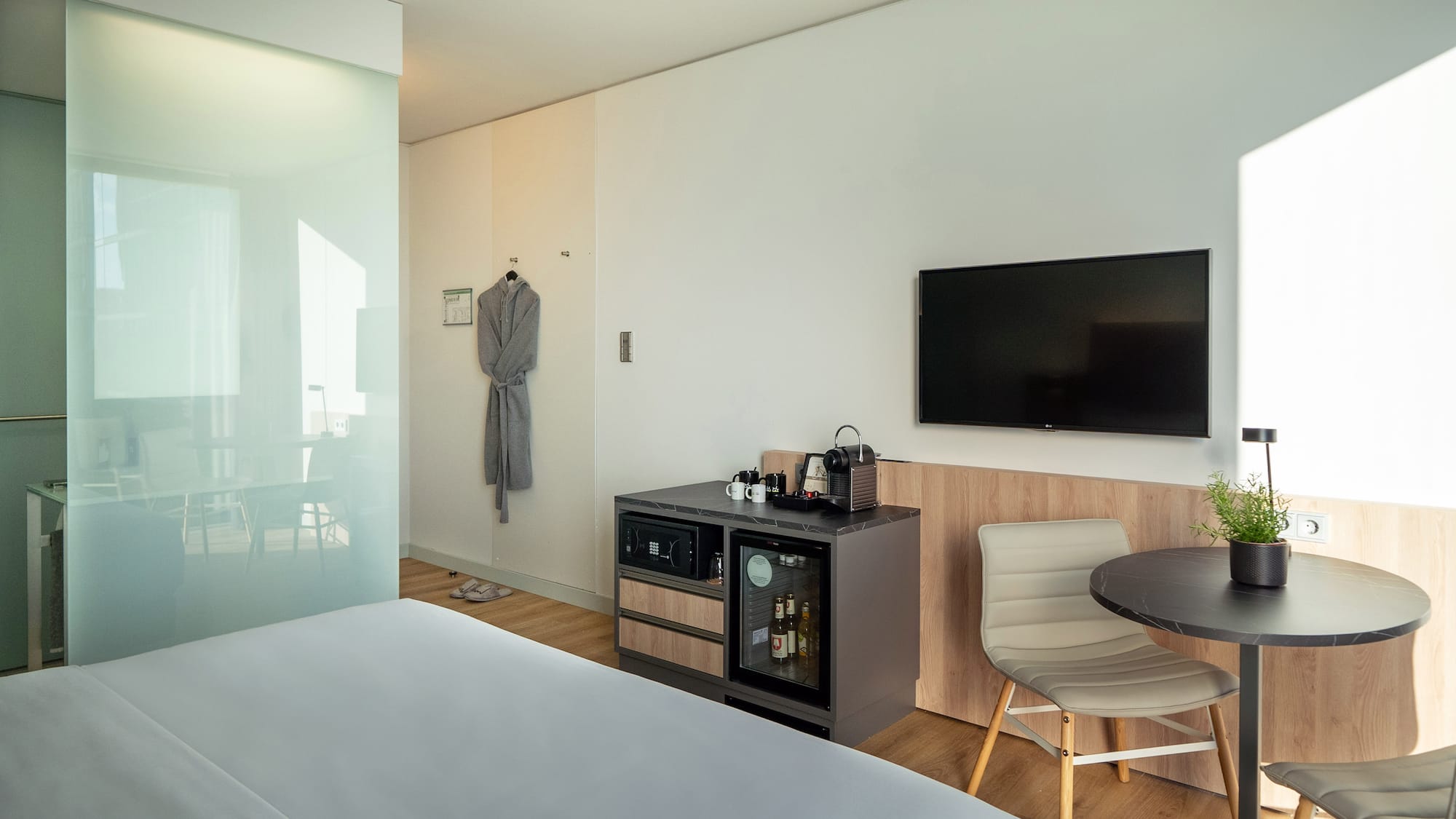 a room with a bed and a table and chair