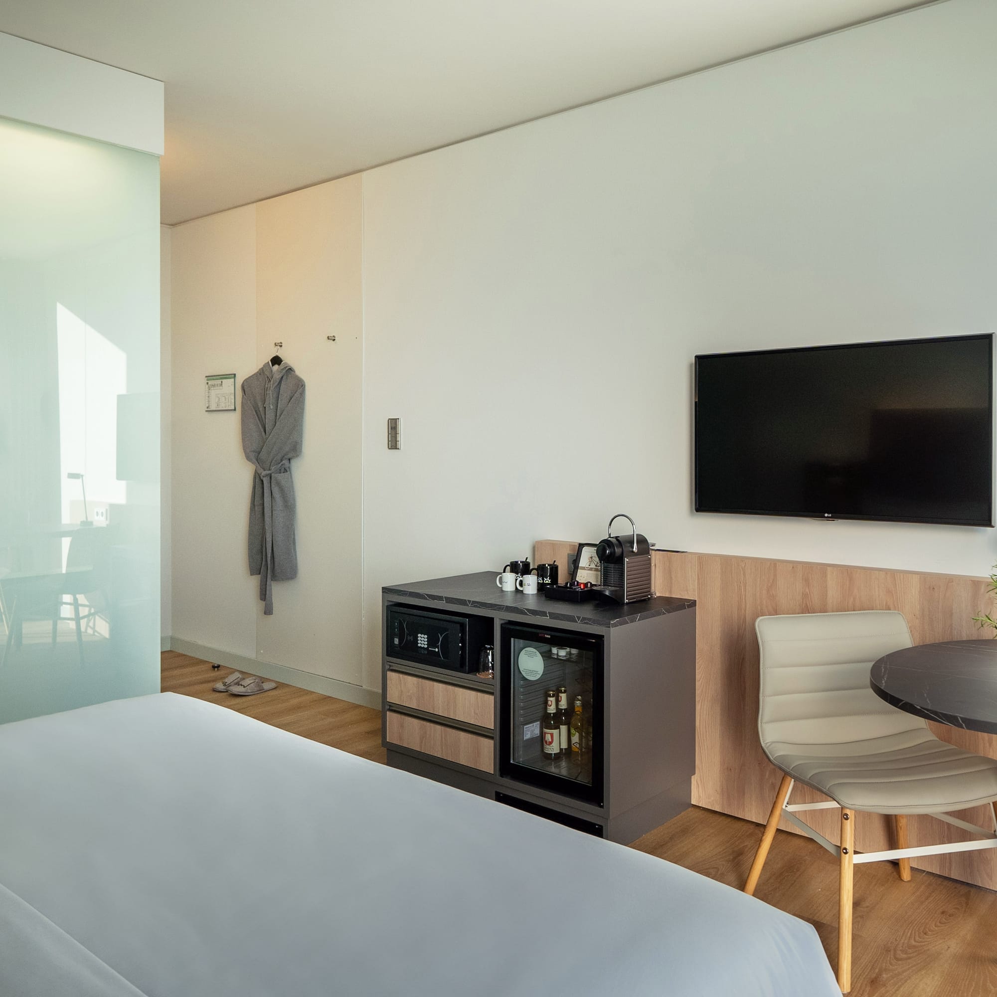 a room with a bed and a table and chair