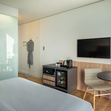 a room with a bed and a table and chair