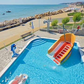 a pool with a slide and a boat