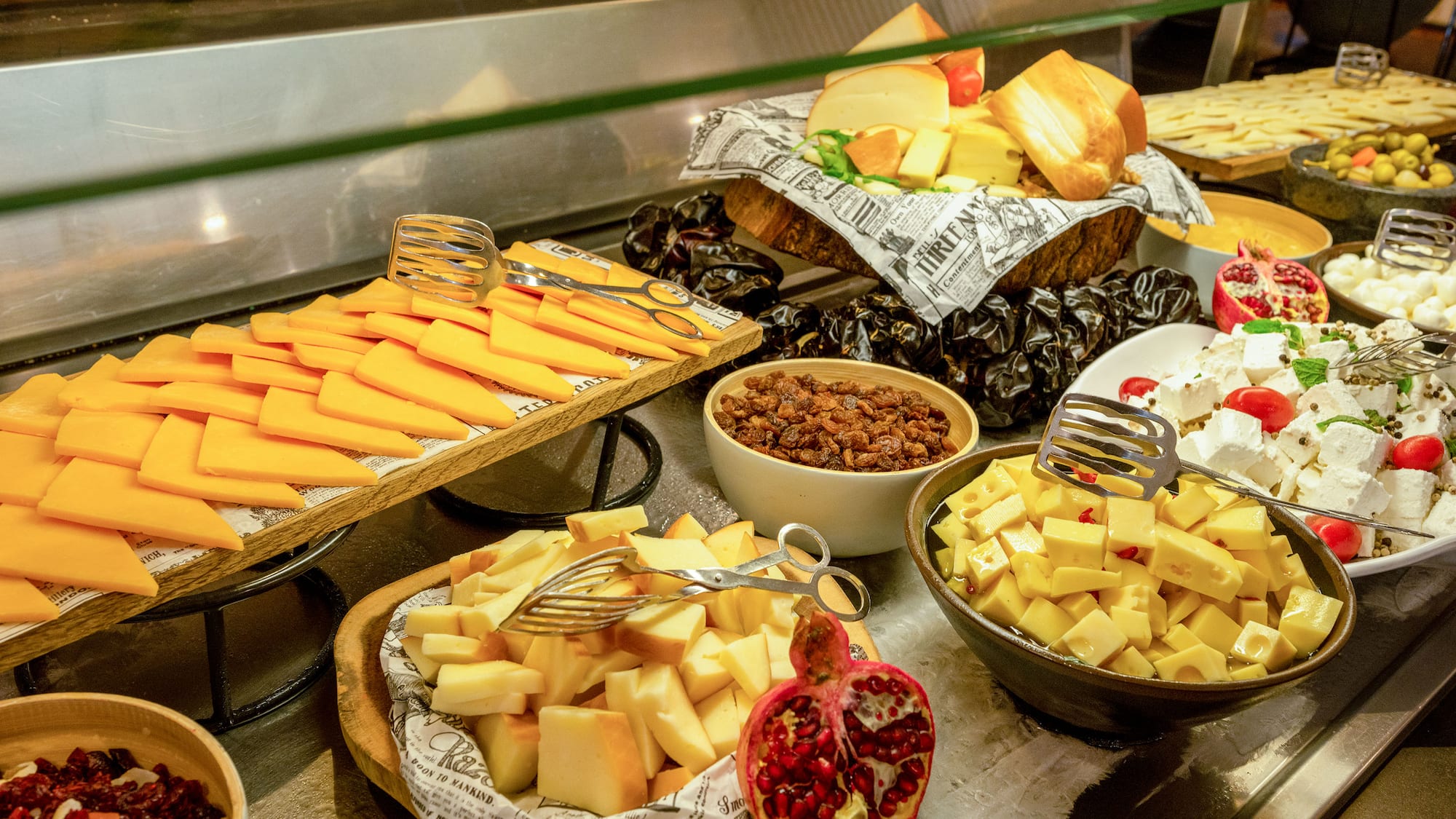 a variety of cheeses and other food on a counter