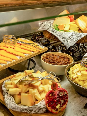 a variety of cheeses and other food on a counter