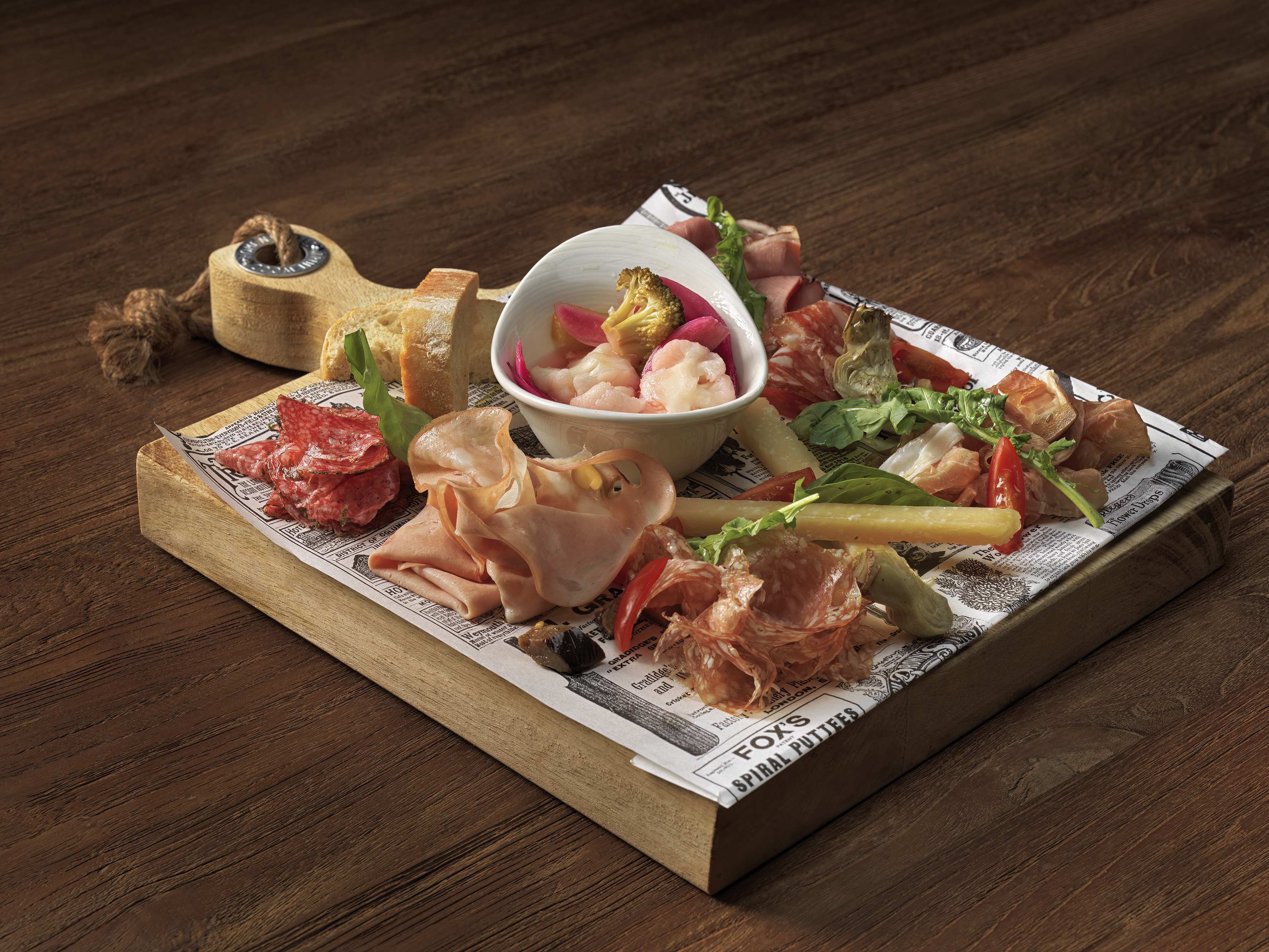 Charcuterie board with cured meats, cheese, shrimp, and fresh bread.