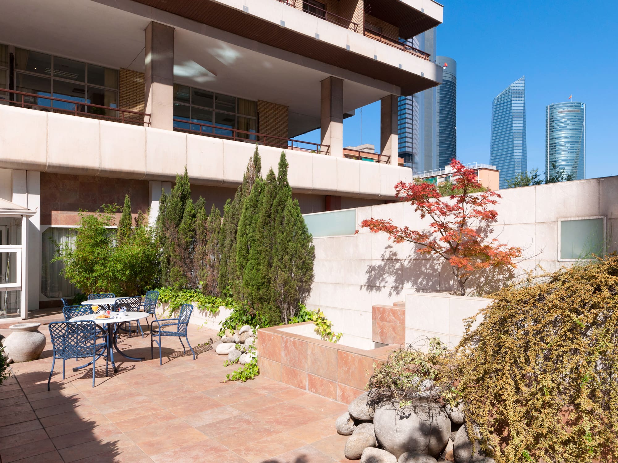 A patio features a table and chairs situated in front of a building.