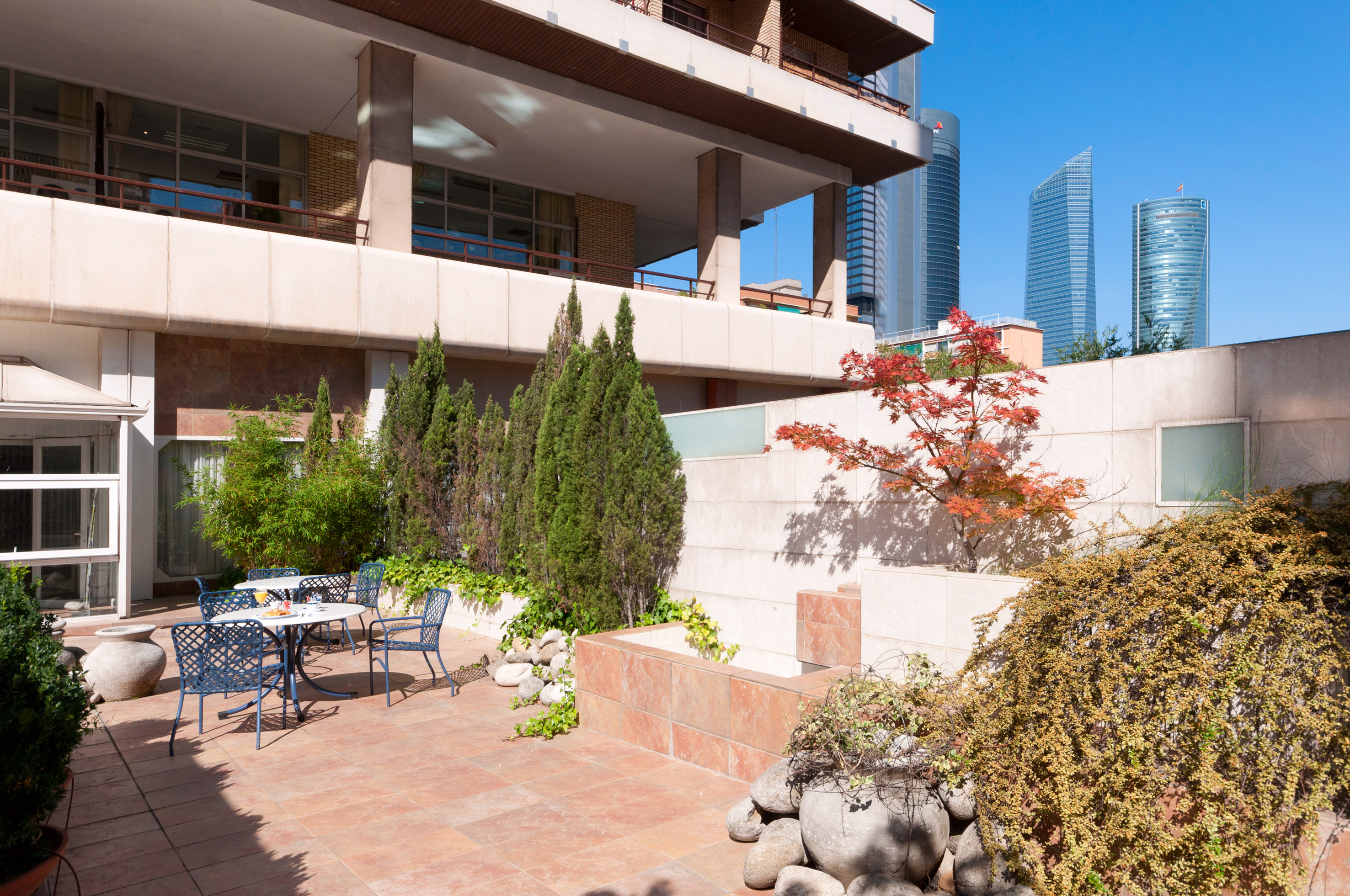 A patio features a table and chairs situated in front of a building.
