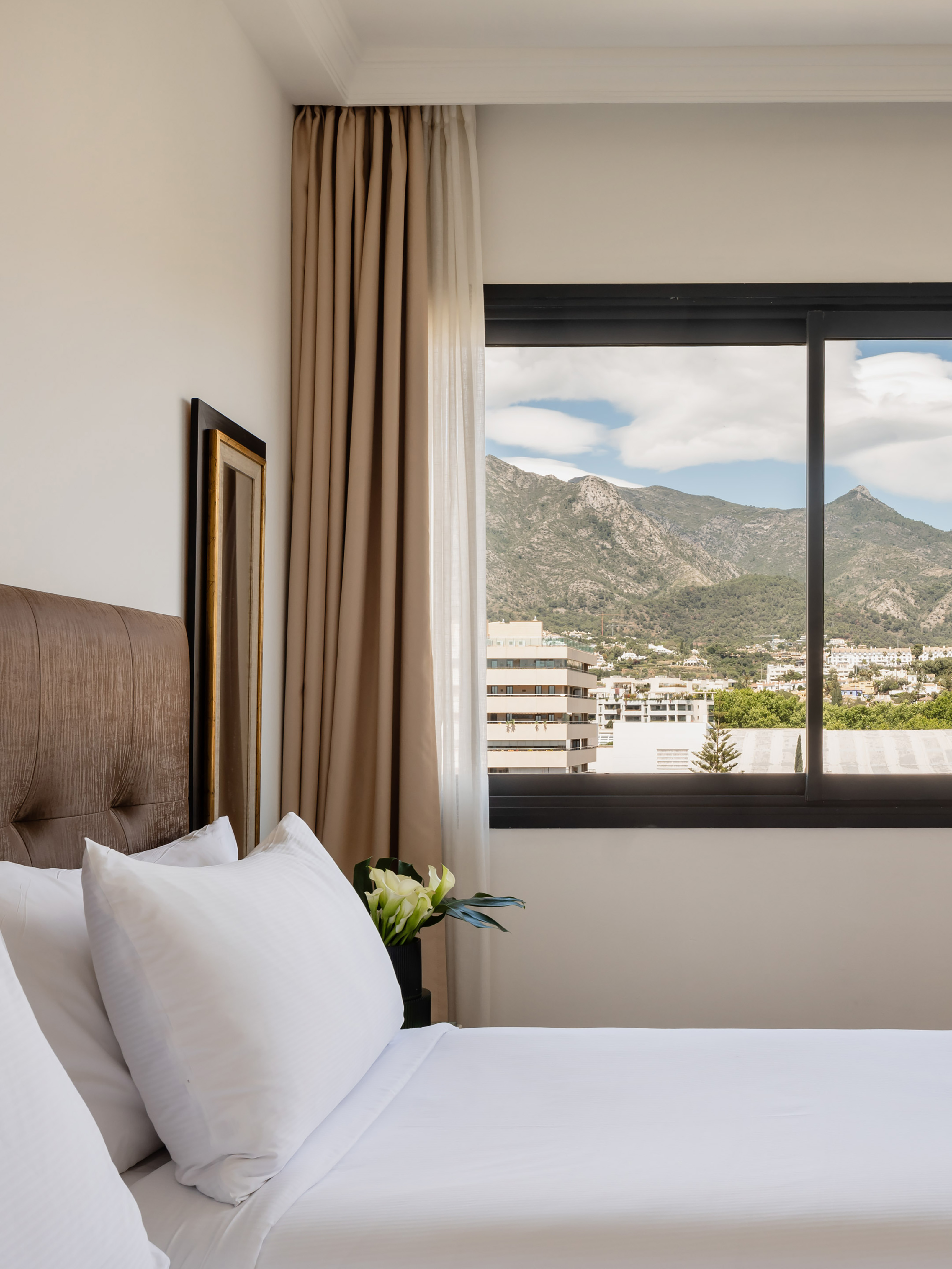 a bed with a window and a view of mountains