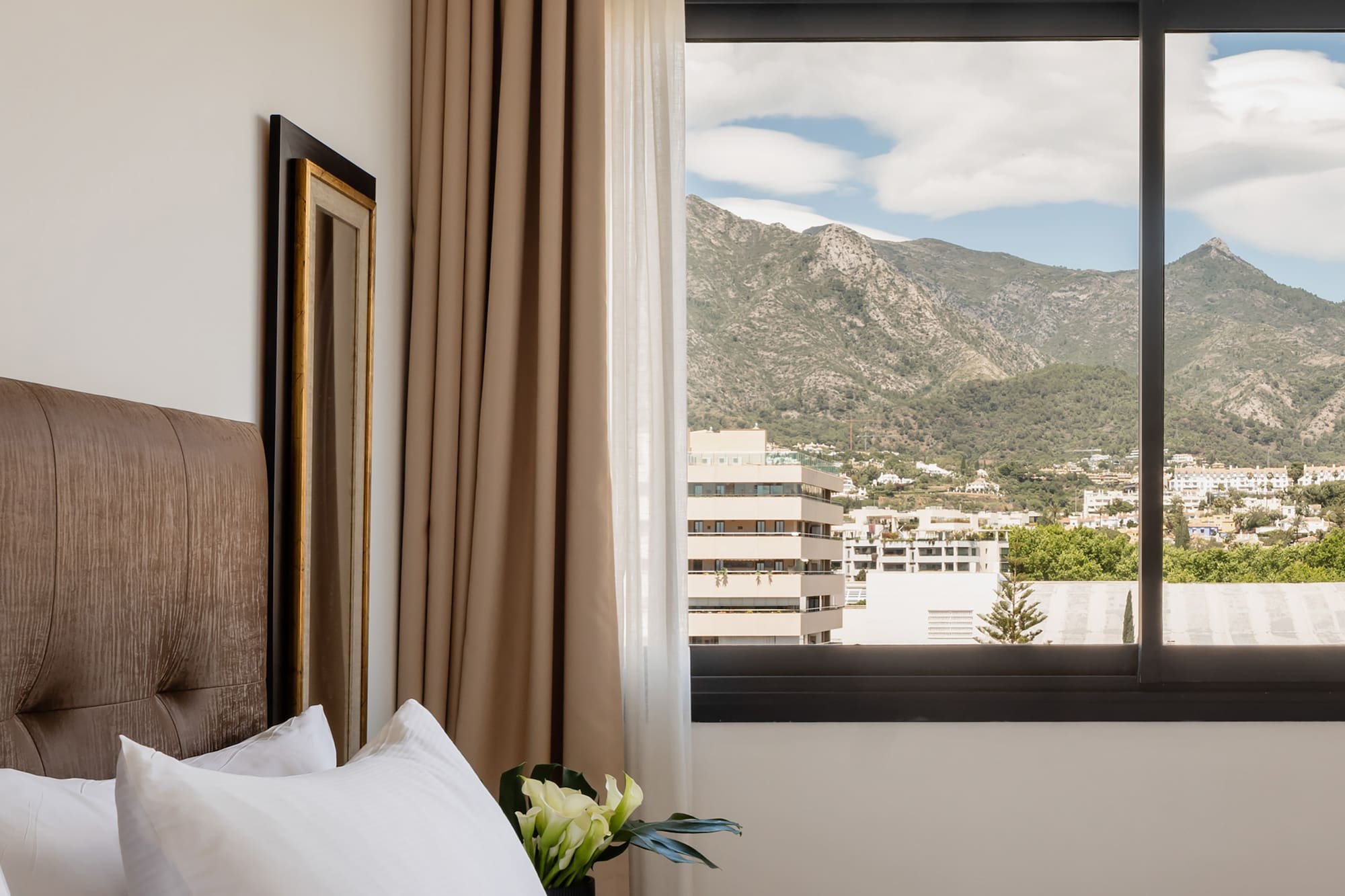 a bed with a window and a view of mountains