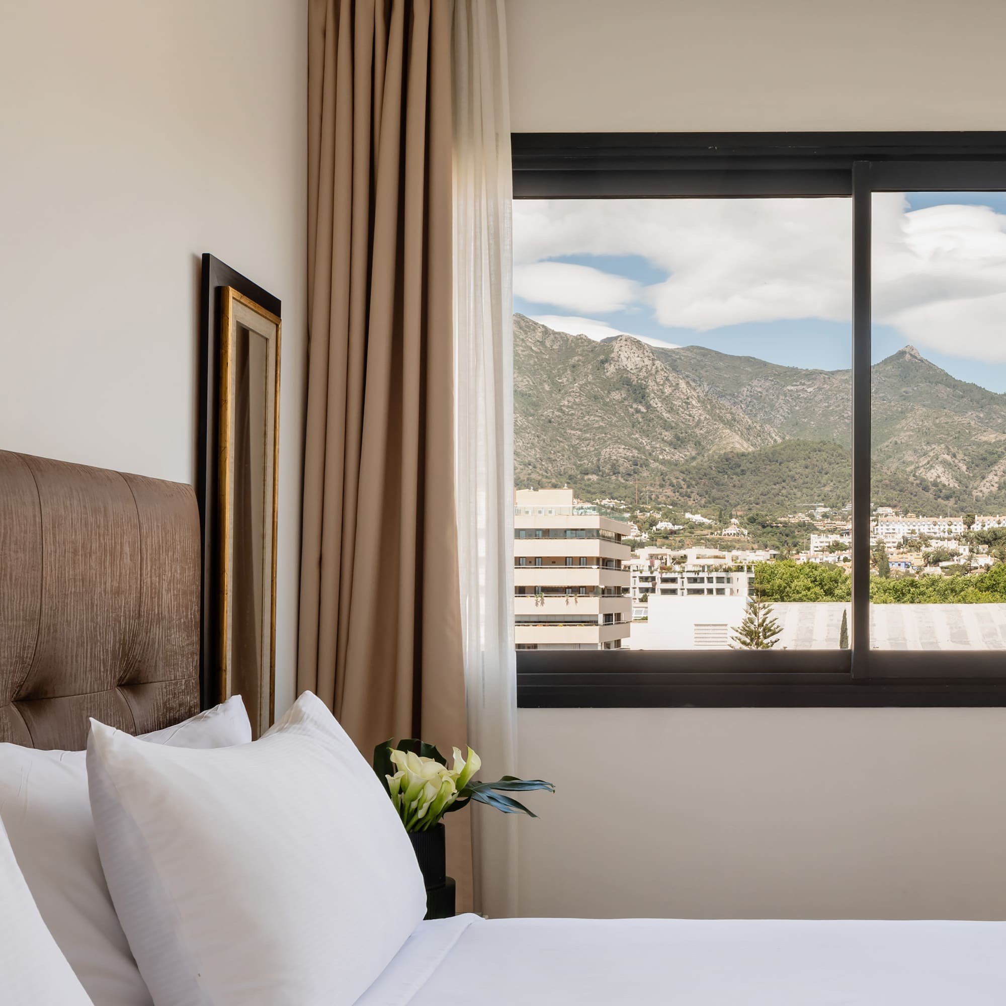 a bed with a window and a view of mountains