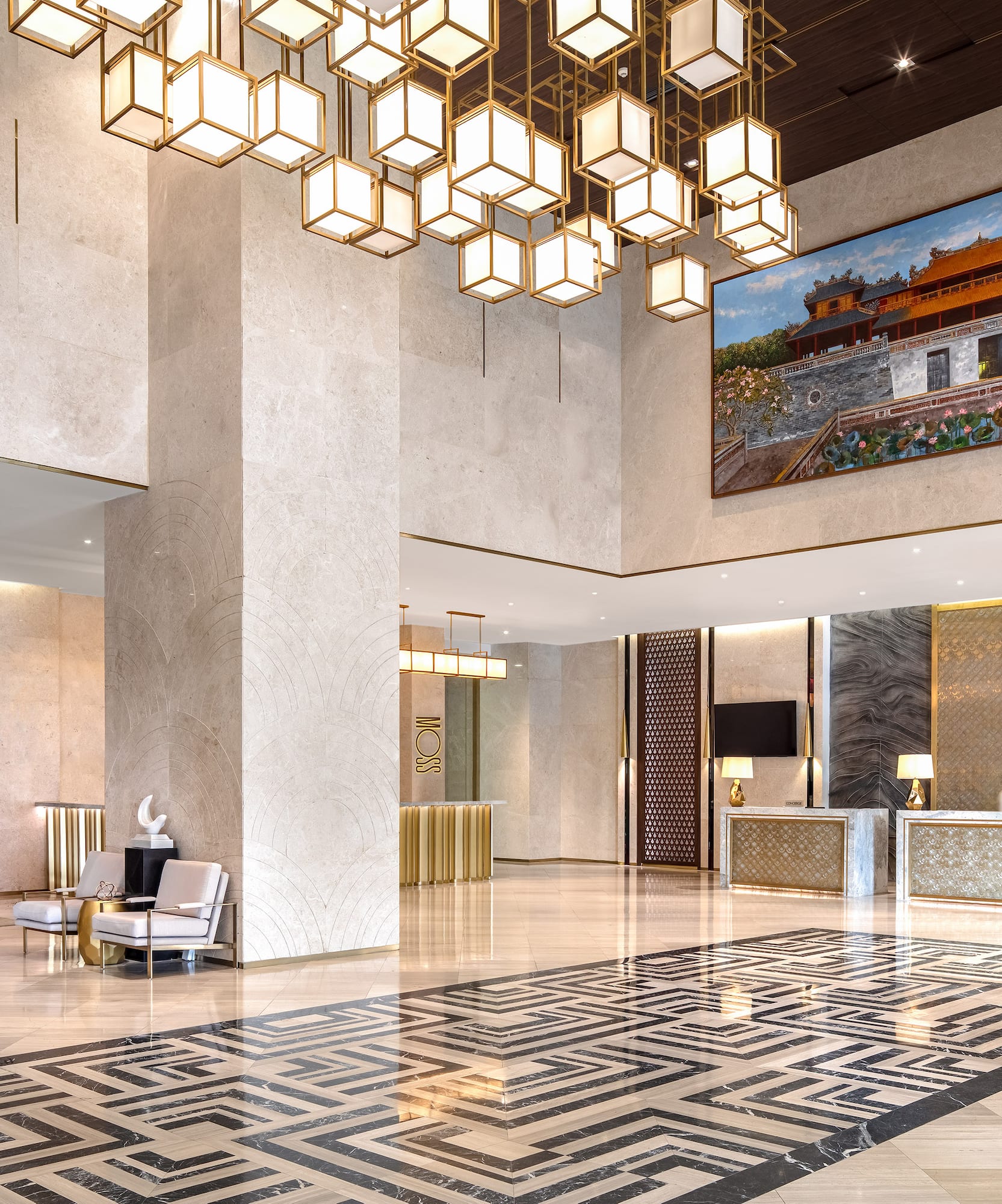 a lobby with a large chandelier and a large picture from the ceiling