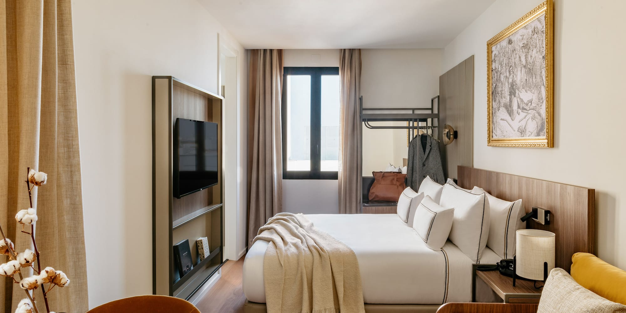 a room with a bed and a television