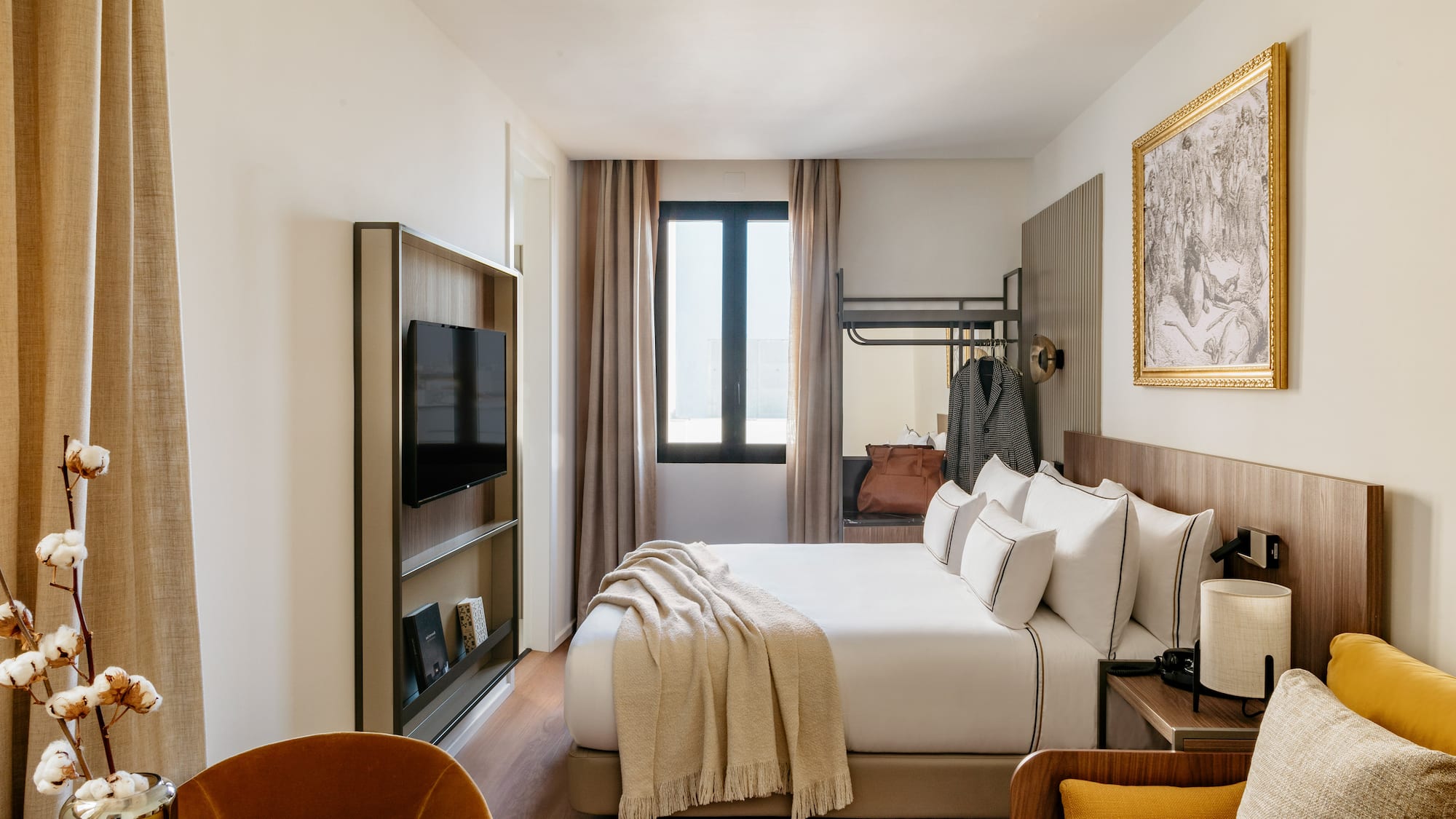 a room with a bed and a television