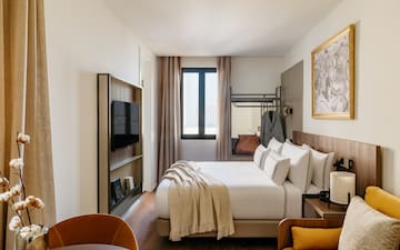 a room with a bed and a television