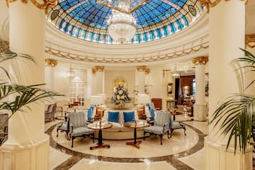 a room with a glass ceiling and a chandelier
