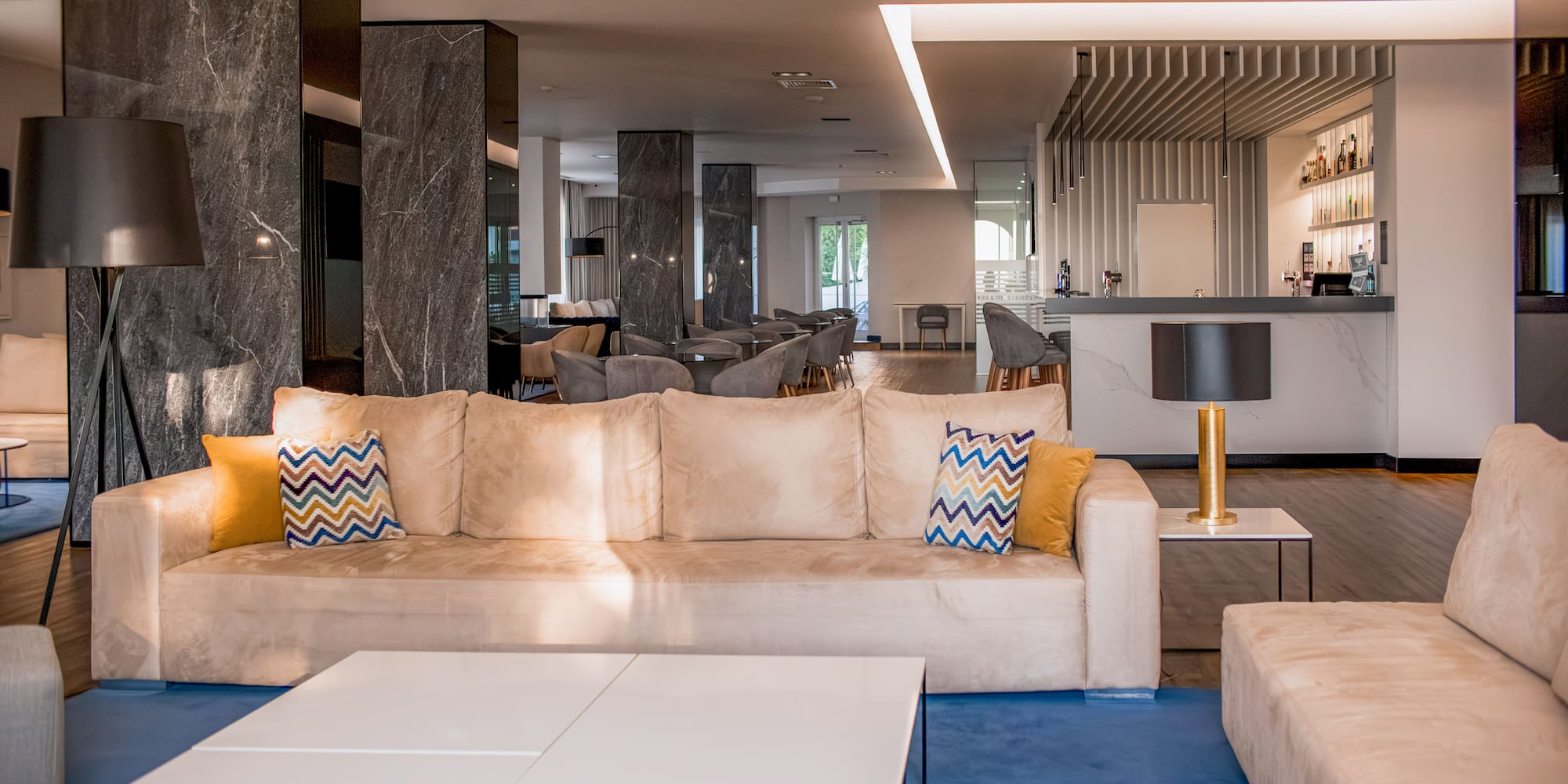 a large living room with a couch and a table