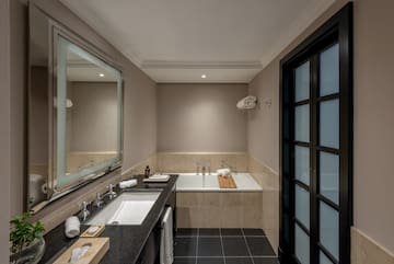 a bathroom with a bathtub and a mirror