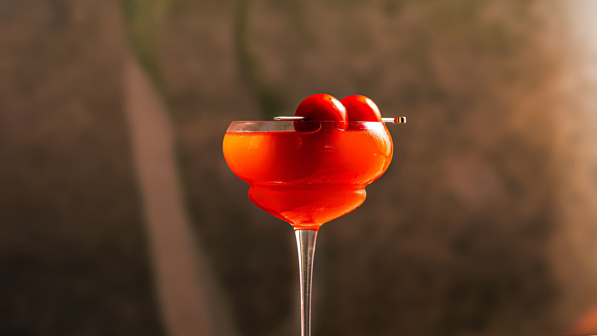 a glass with a drink and a straw