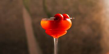 a glass with a drink and a straw