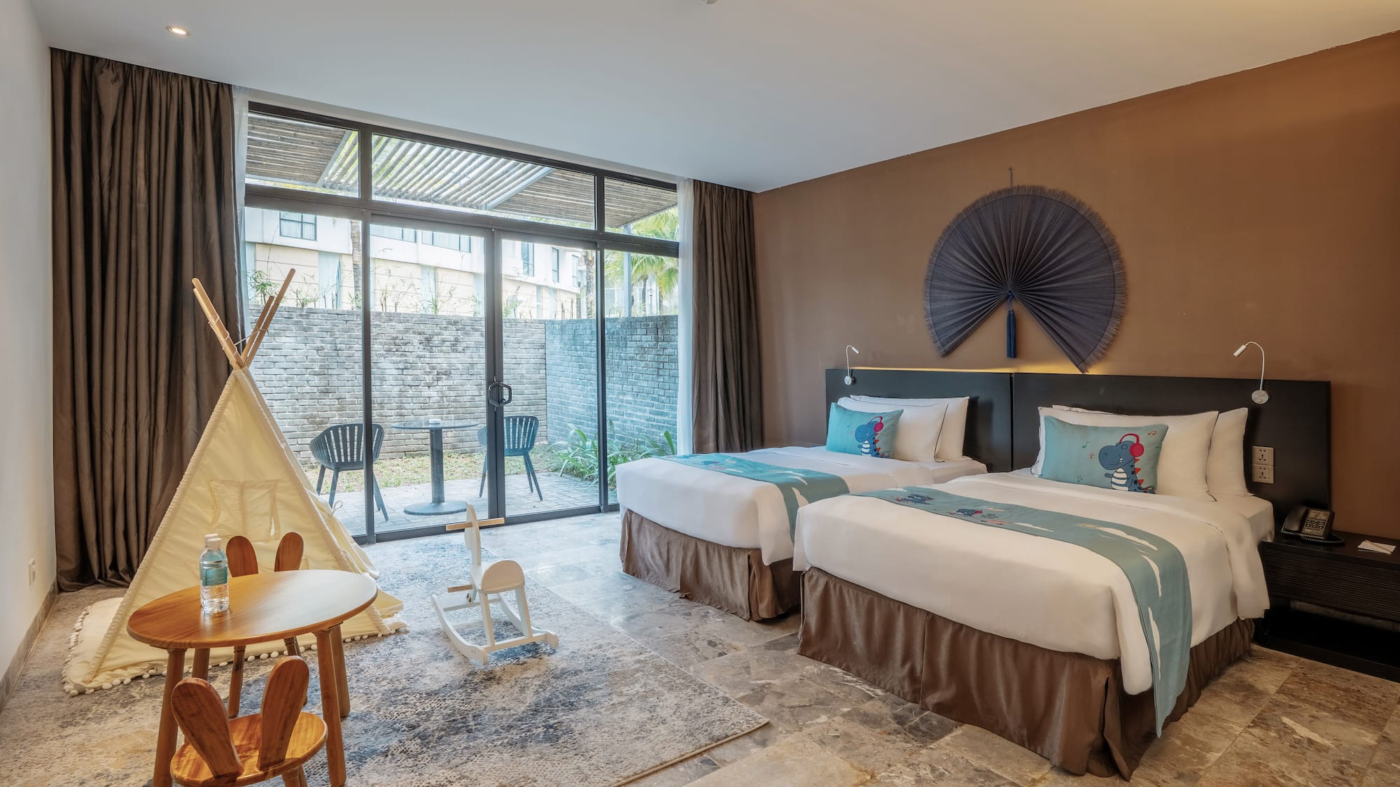 a room with two beds and a table