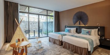 a room with two beds and a table