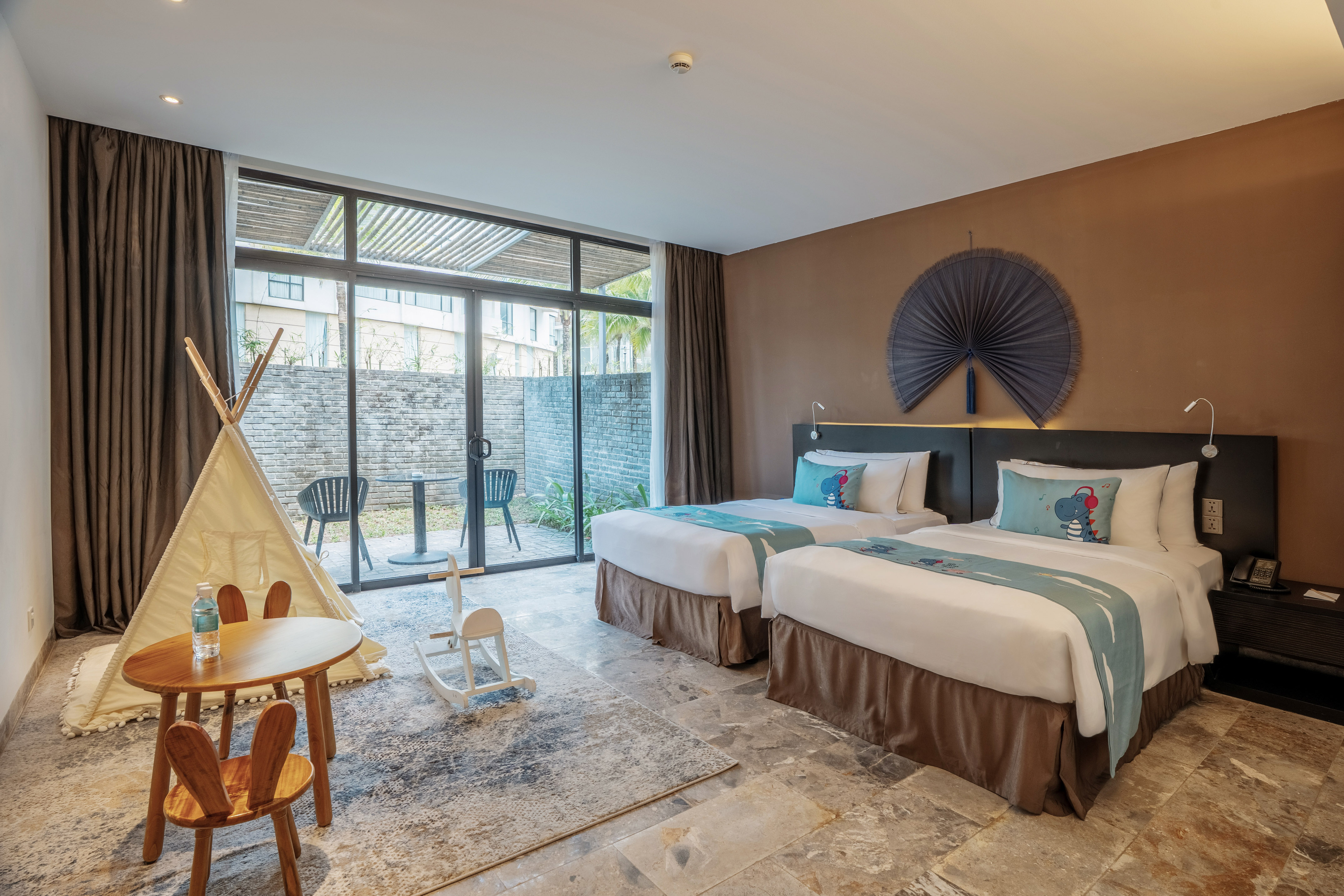 a room with two beds and a table