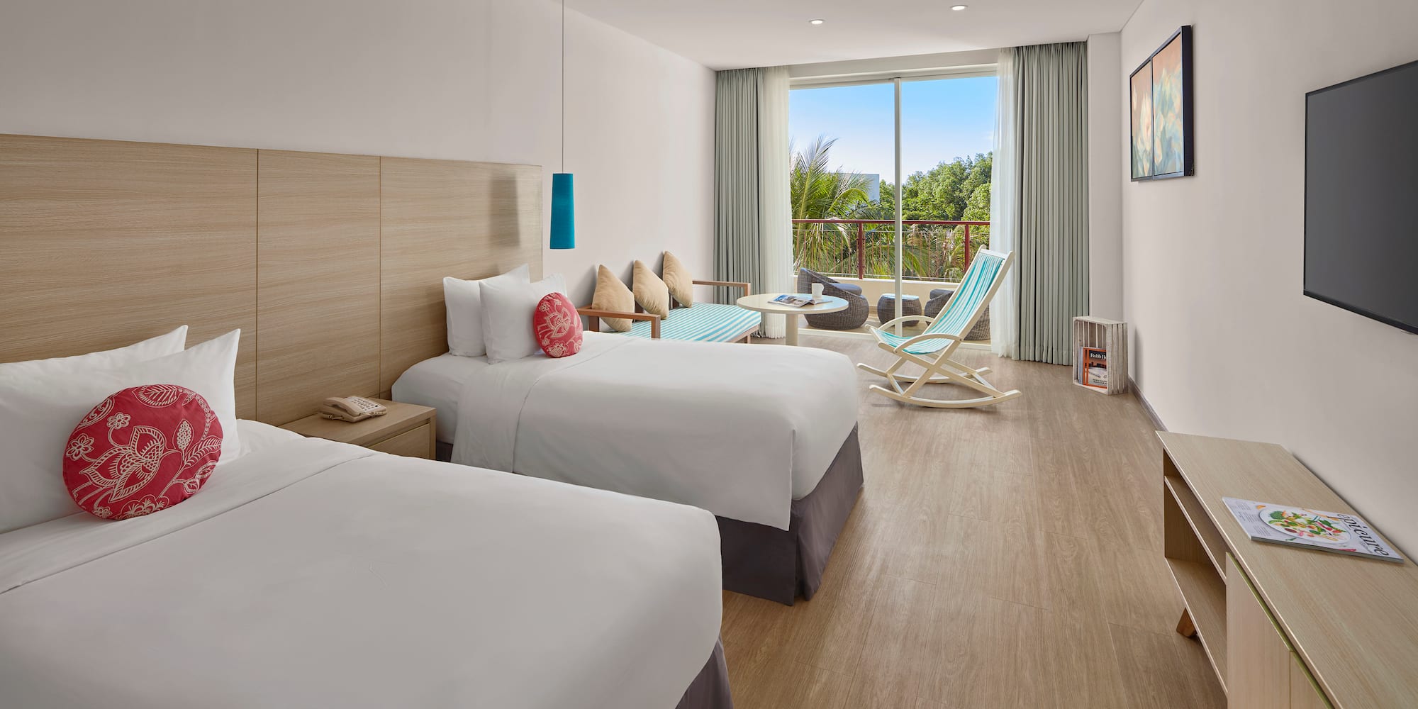 a room with two beds and a chair