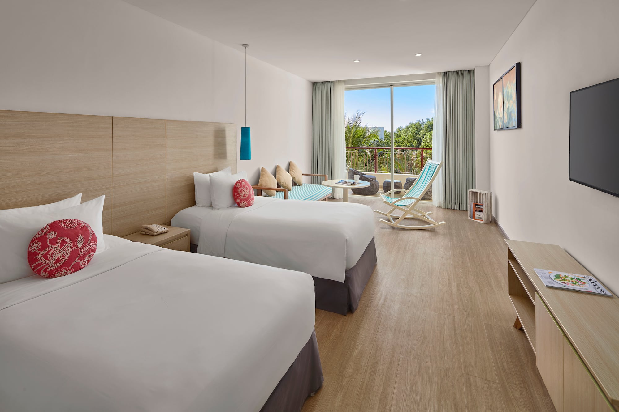 a room with two beds and a chair