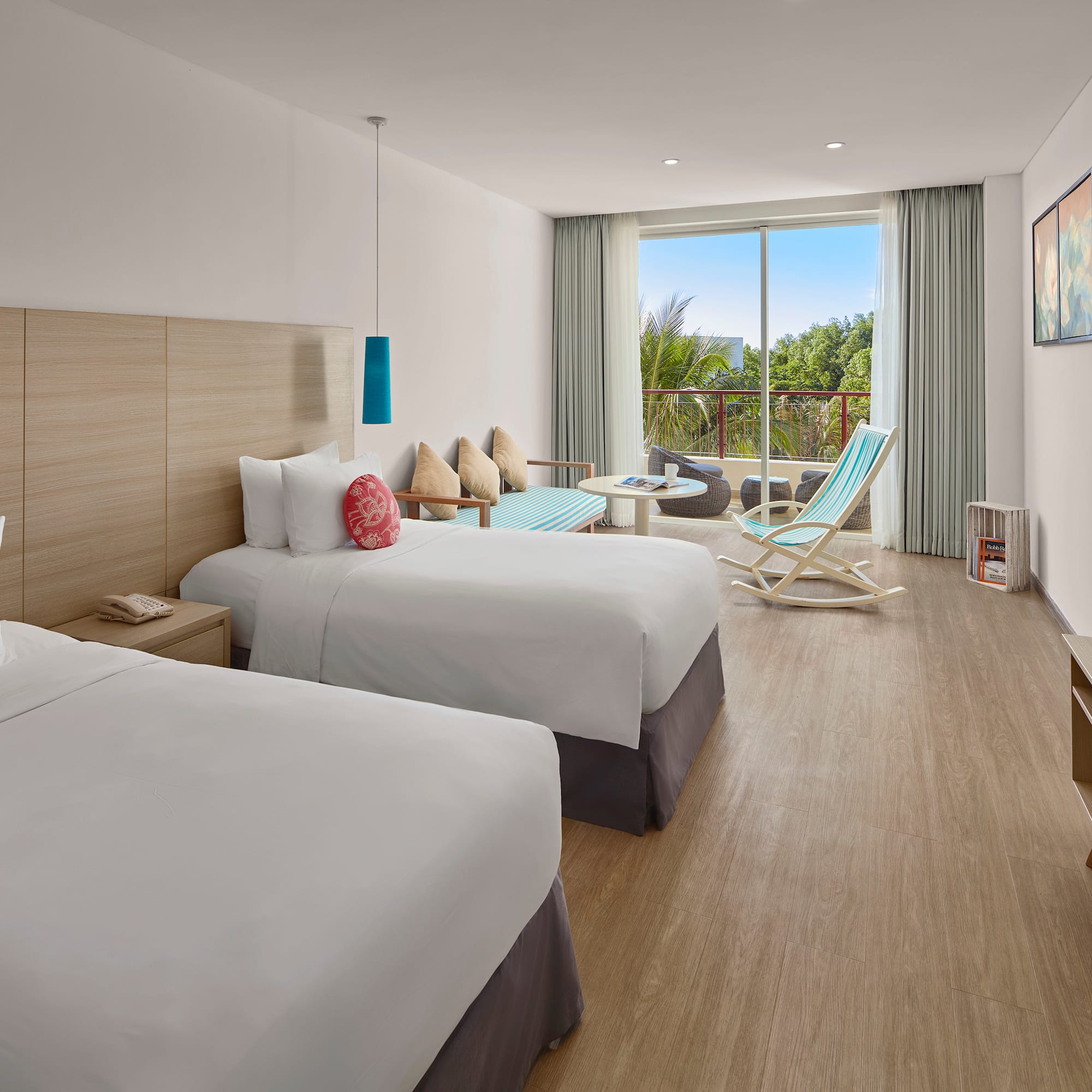 a room with two beds and a chair