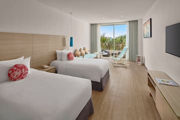 a room with two beds and a chair