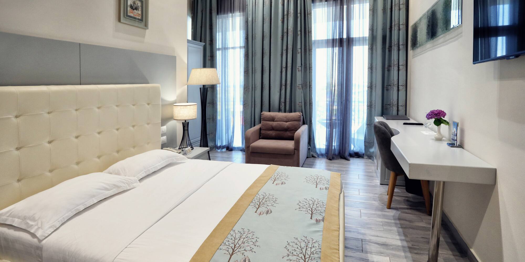 a bedroom with a bed and a chair and a desk