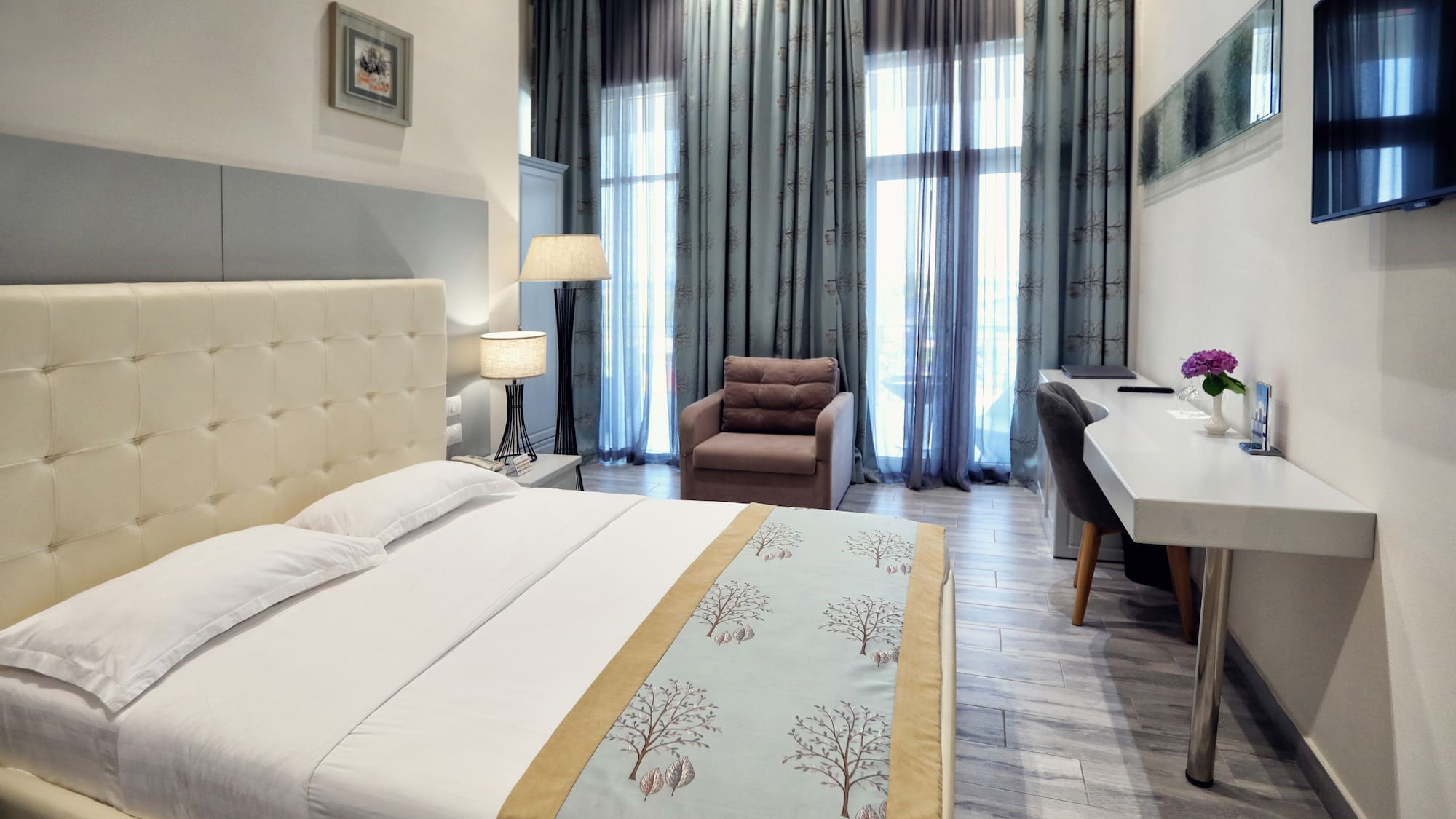 a bedroom with a bed and a chair and a desk