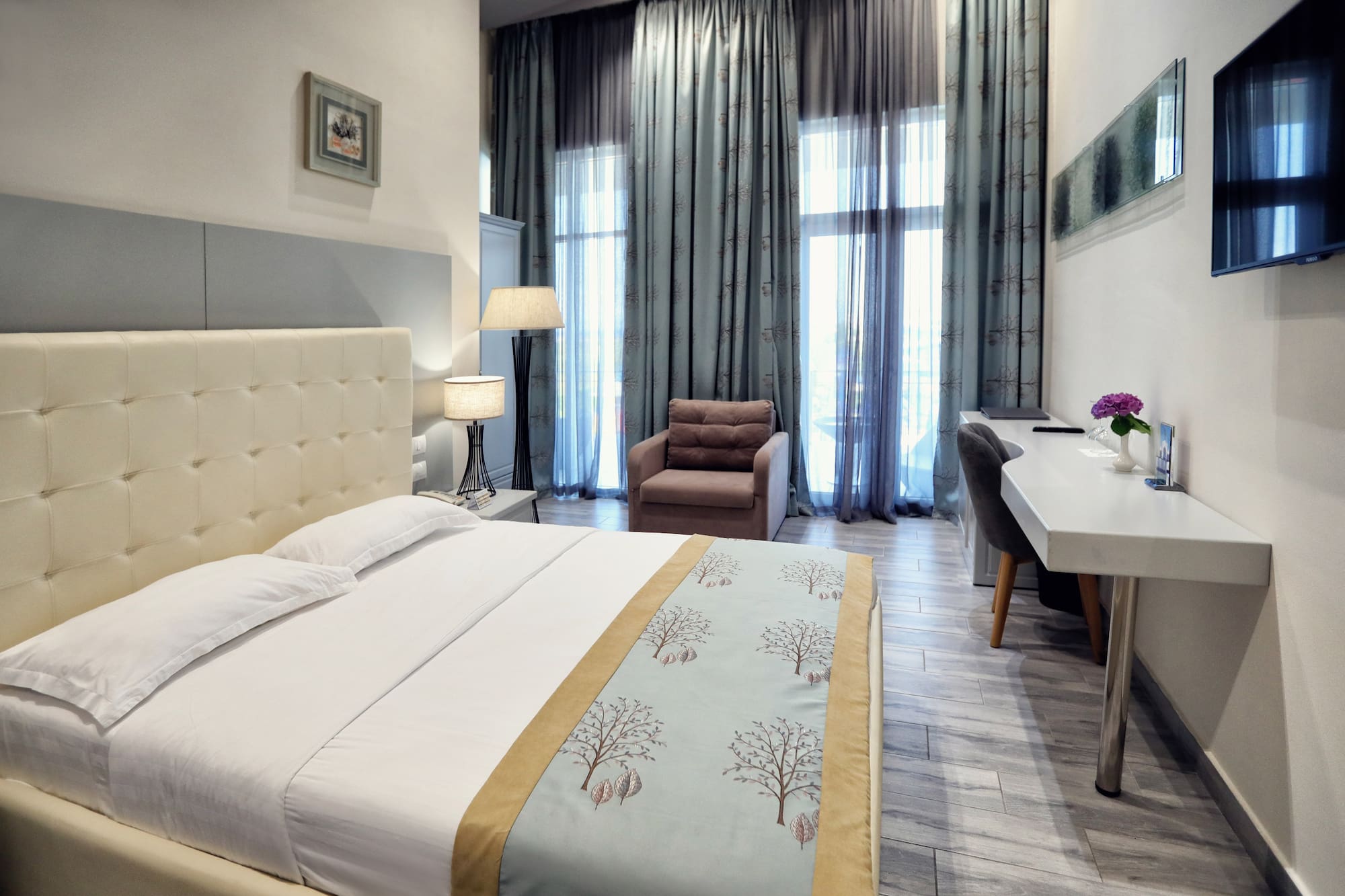 a bedroom with a bed and a chair and a desk